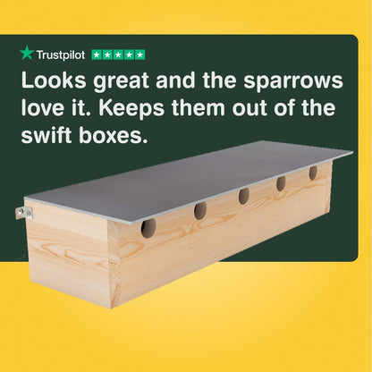 Wooden bird barrier with text on a yellow and green background